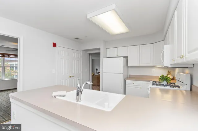 a kitchen with sink and cabinets