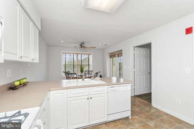 a dining room with furniture a rug and a large window