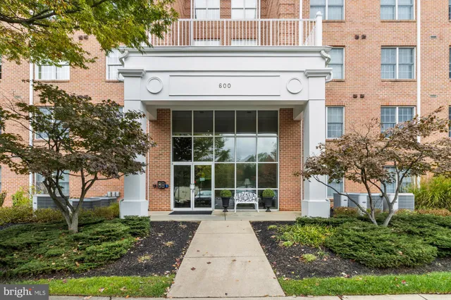 a view of a building with a window and potted plants