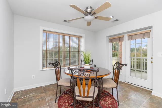 a dining room with furniture and a chandelier