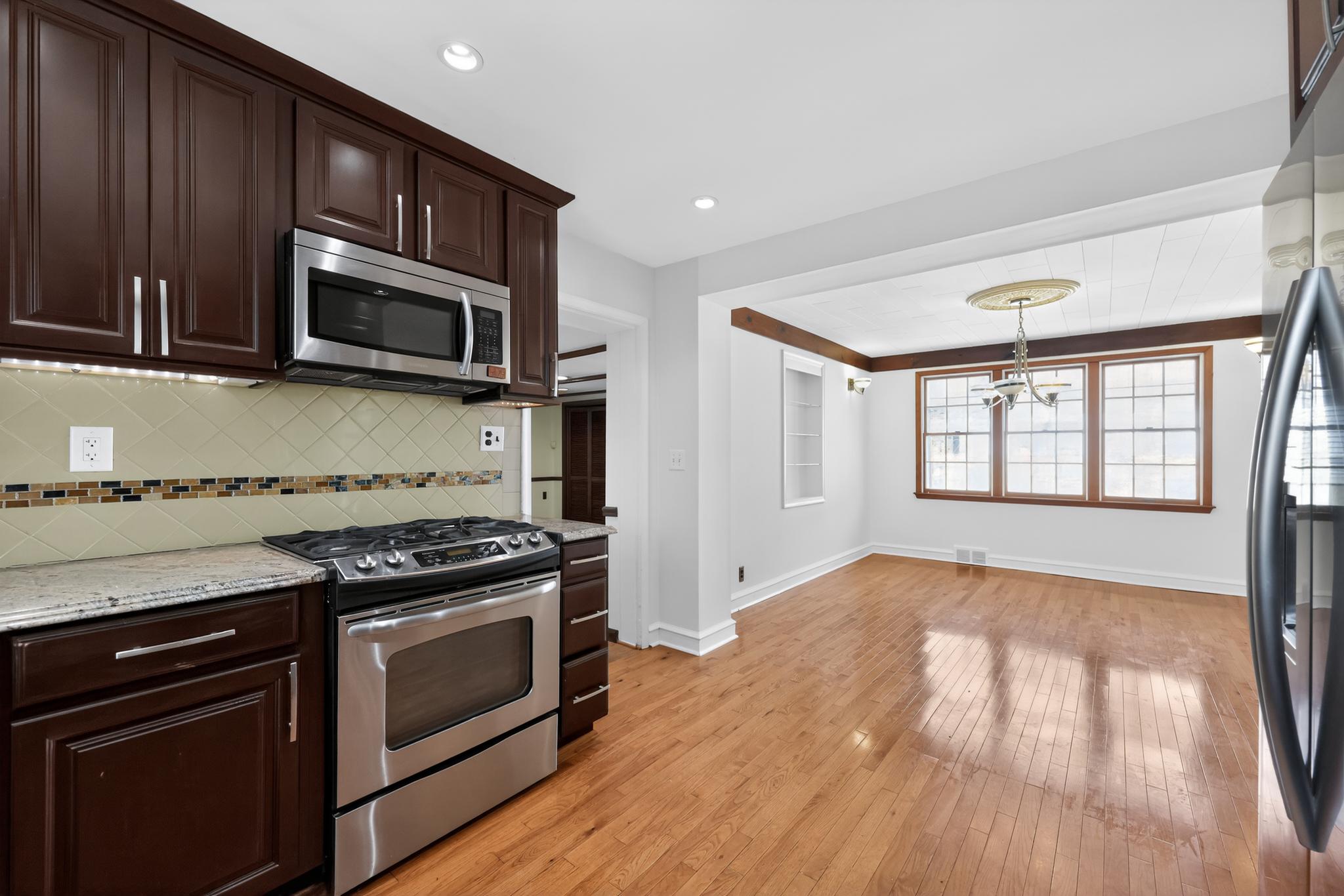36 Decatur Road Havertown, PA 19083 - Photo 11 of 35 a kitchen with stainless steel appliances wooden cabinets and a stove top oven