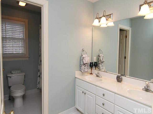 236 Release Circle Raleigh, NC 27615 - Photo 17 of 25 a bathroom with a toilet a sink and mirror