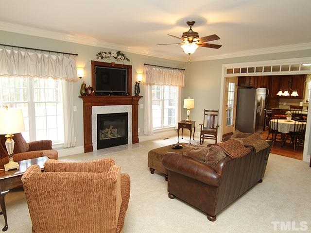 236 Release Circle Raleigh, NC 27615 - Photo 5 of 25 a living room with furniture a fireplace and a flat screen tv