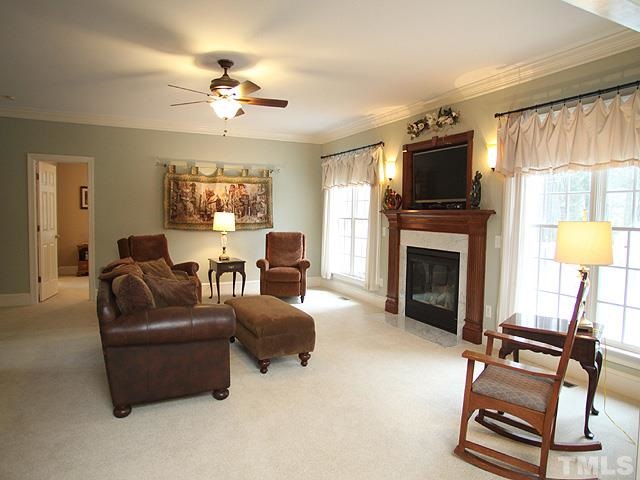 236 Release Circle Raleigh, NC 27615 - Photo 7 of 25 a living room with furniture a fireplace and a flat screen tv