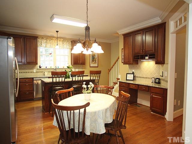 236 Release Circle Raleigh, NC 27615 - Photo 8 of 25 a kitchen with granite countertop a sink dining table and chairs