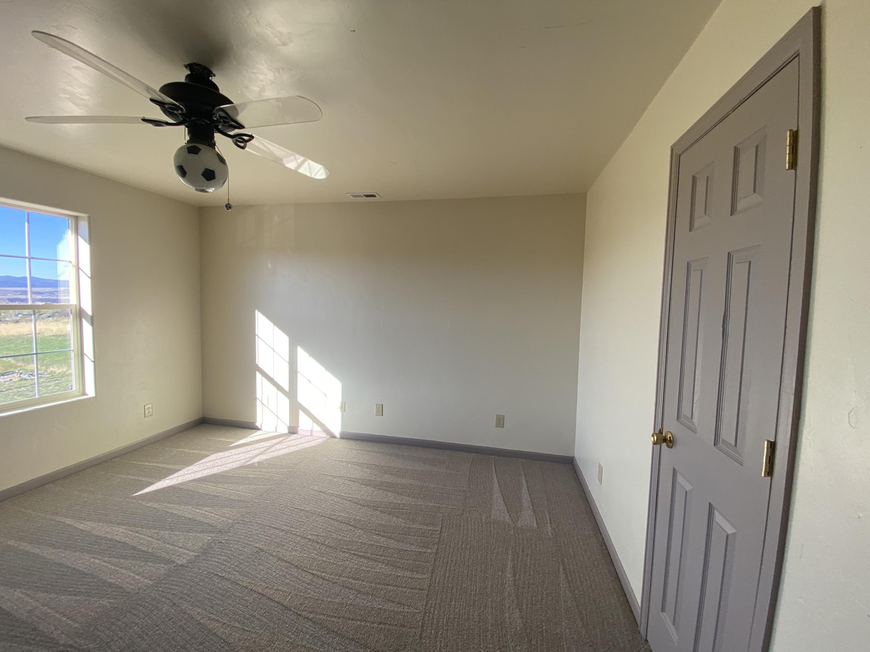 658 Cindys Way Rifle, CO 81650 - Photo 13 of 30 a view of an empty room and a window and a ceiling fan