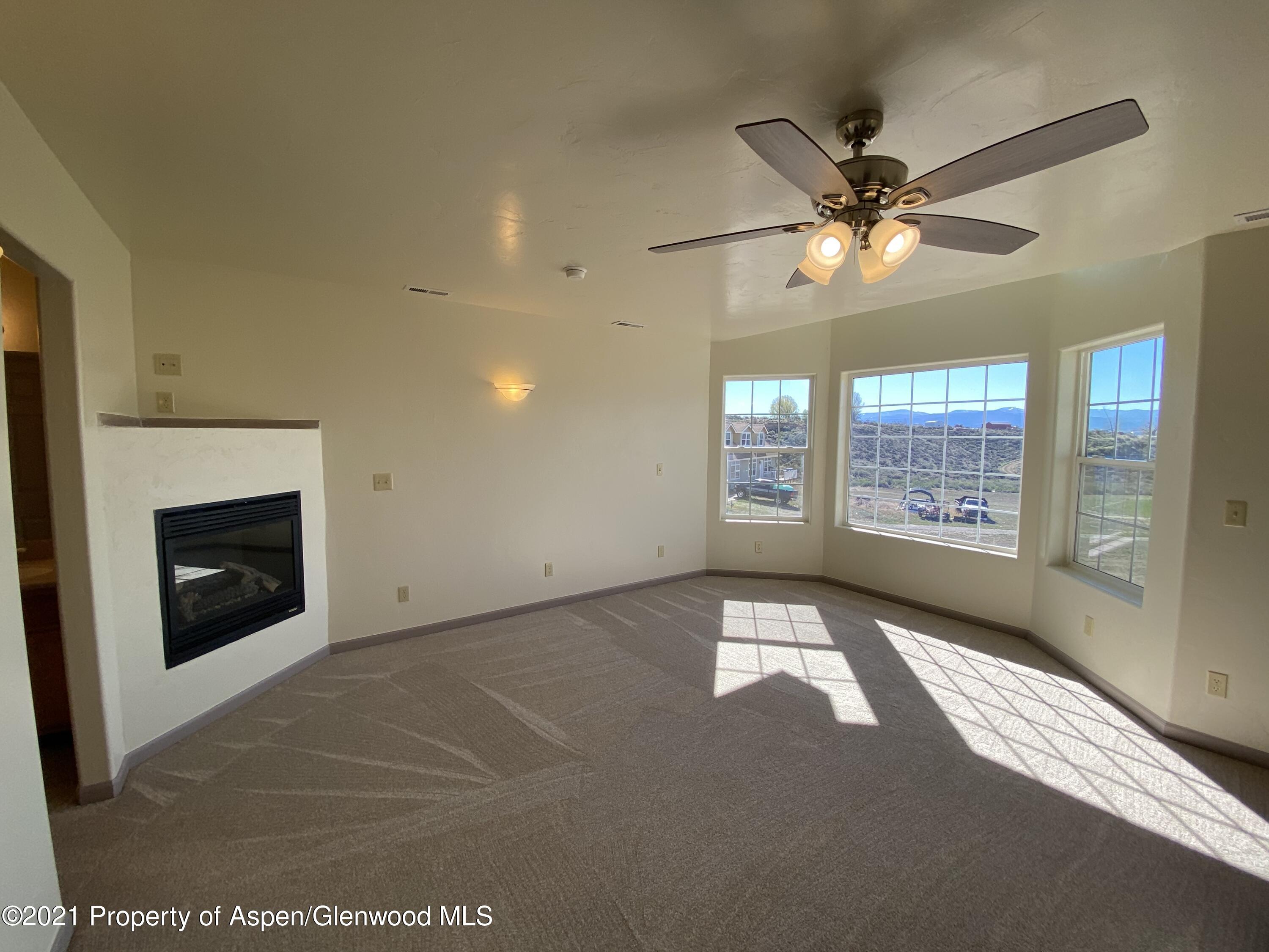 658 Cindys Way Rifle, CO 81650 - Photo 16 of 30 a view of an empty room with a window and fireplace