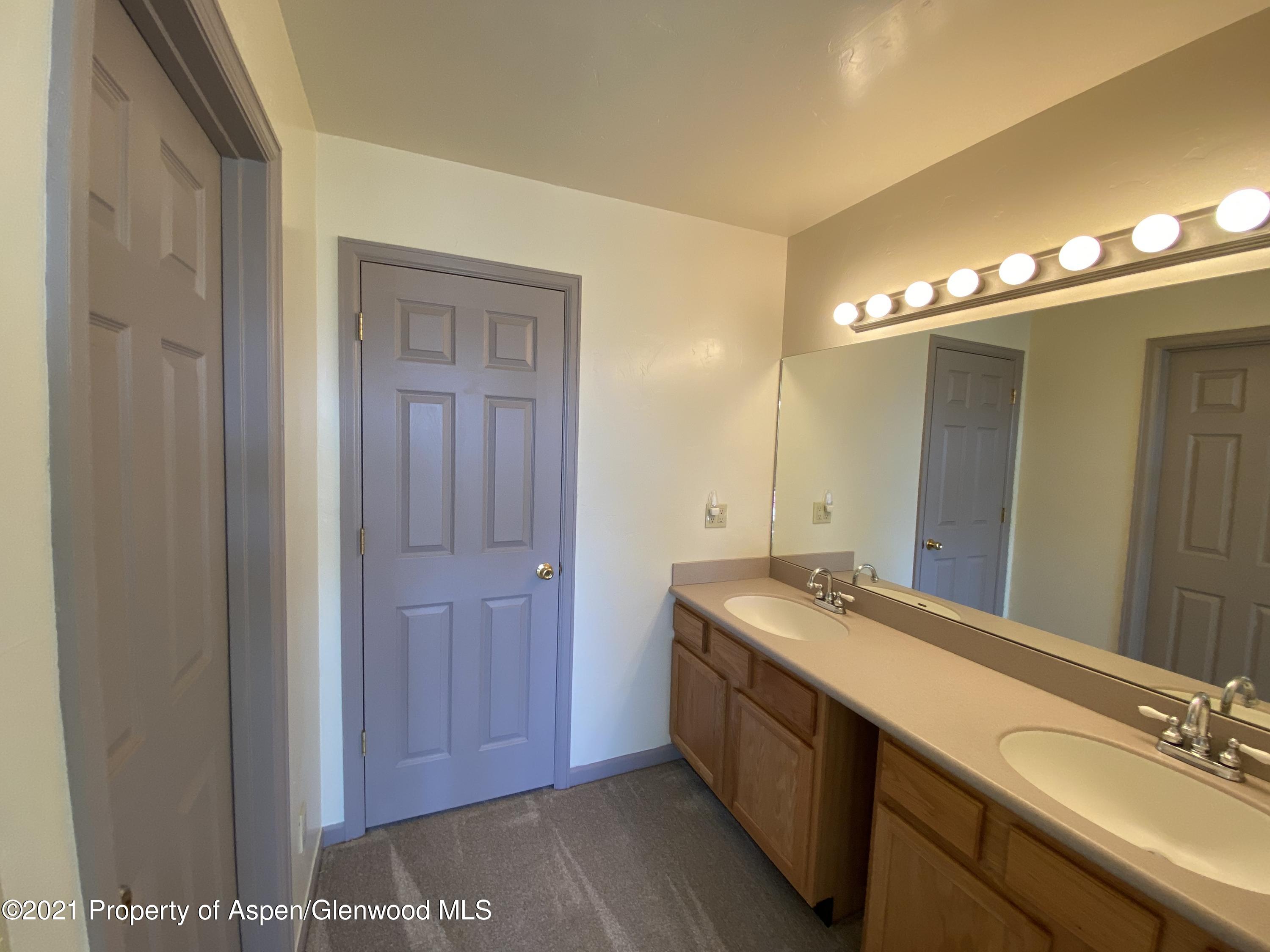 658 Cindys Way Rifle, CO 81650 - Photo 18 of 30 a bathroom with a sink and a mirror