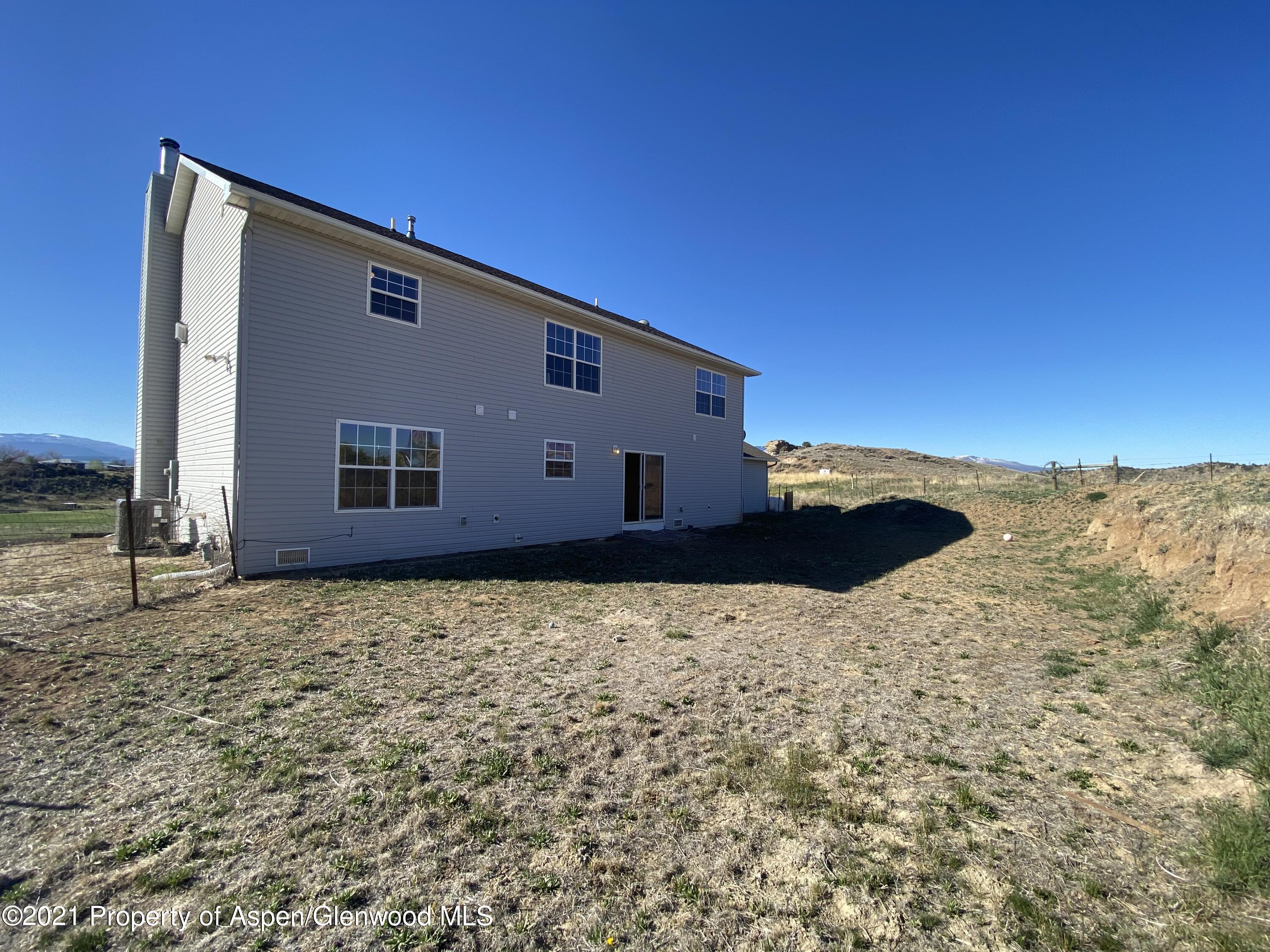 658 Cindys Way Rifle, CO 81650 - Photo 25 of 30 a backyard of a house with a yard