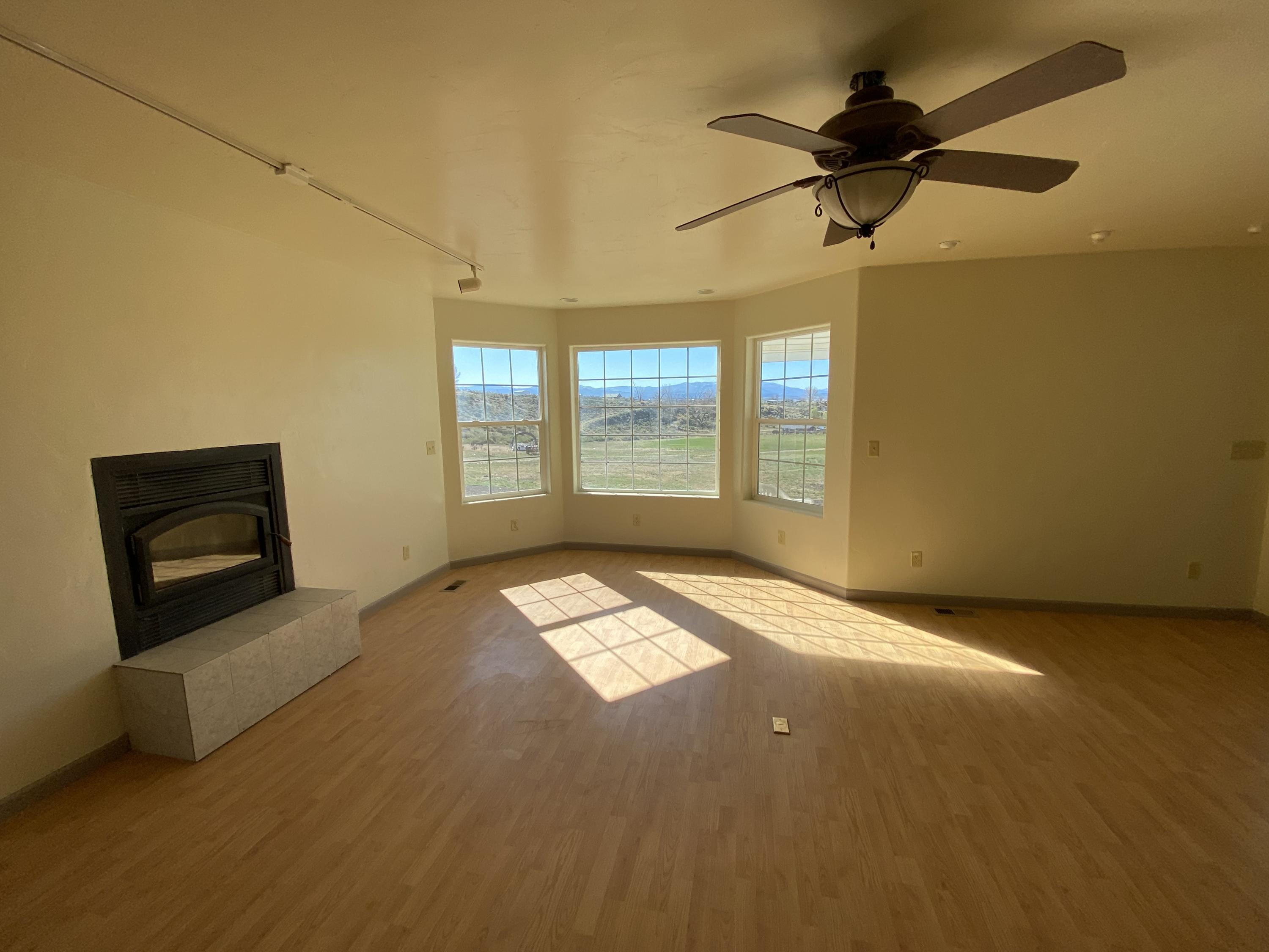 658 Cindys Way Rifle, CO 81650 - Photo 9 of 30 a view of an empty room with a window and a fireplace