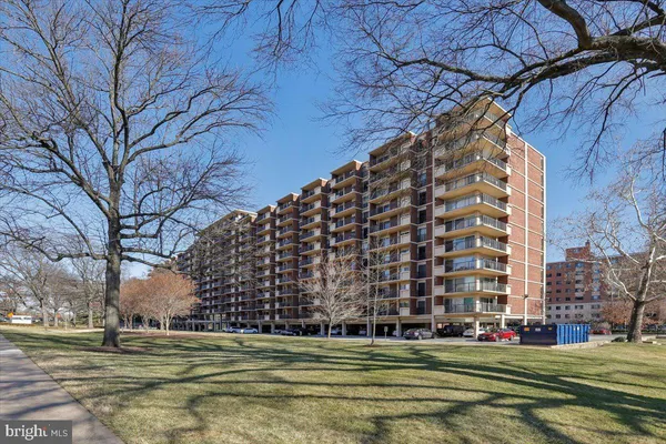 a view of building with trees in front of it