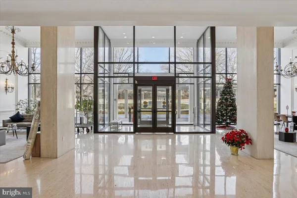 a living room with furniture chandelier and a large window