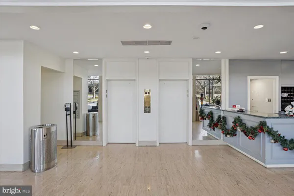 a kitchen with cabinets stainless steel appliances and wooden floor