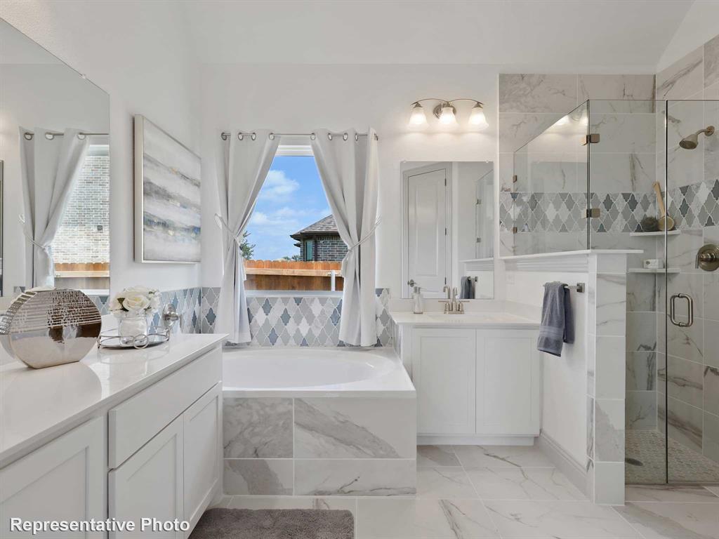 2204 Ridgecrest Lane Anna, TX 75409 - Photo 9 of 17 Bathroom featuring a built-in soaking tub with decorative tile surround, a walk-in shower with glass enclosure, dual vanity sinks, and large format floor tiling