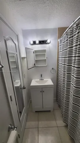 a bathroom with a sink and mirror