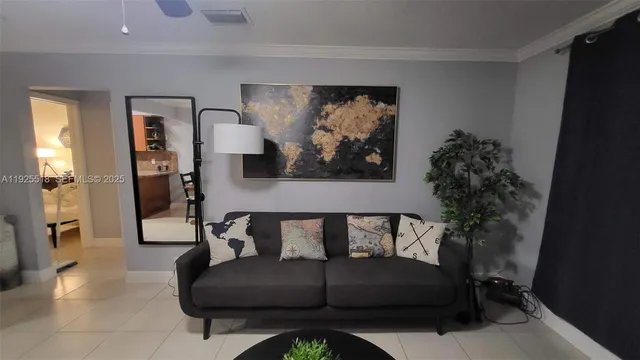 a living room with furniture and a potted plant
