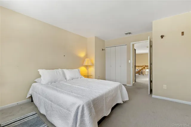 a bedroom with a bed and a painting on the wall