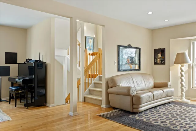 a living room with furniture and a flat screen tv with wooden floor