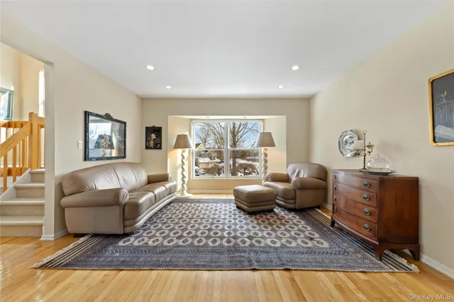 a living room with furniture rug and window