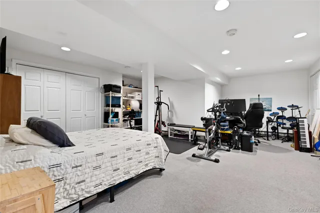 a bedroom with a bed a couch and a large window