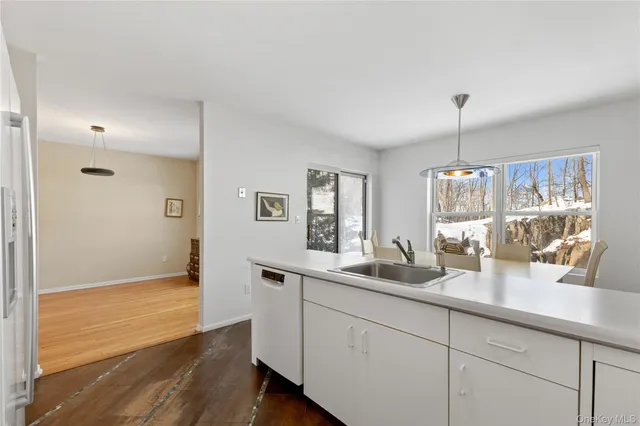 a hallway with sink and mirror