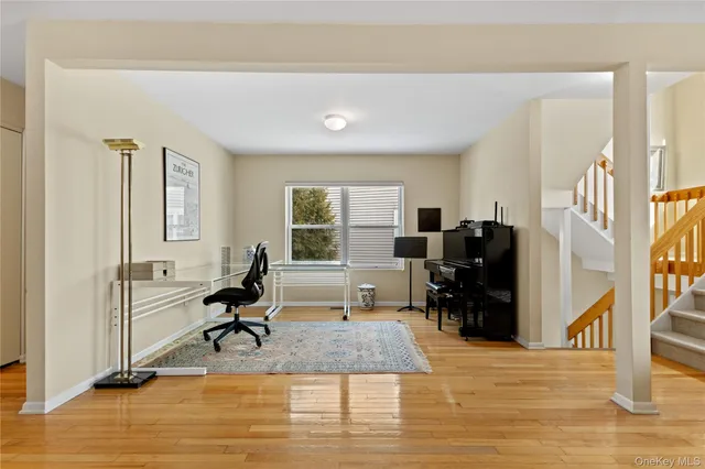a view of a workspace with furniture and a window