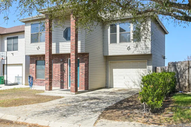 a view of a house with a yard and garage