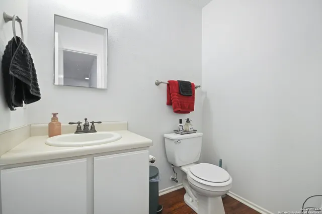 a bathroom with a toilet sink and mirror