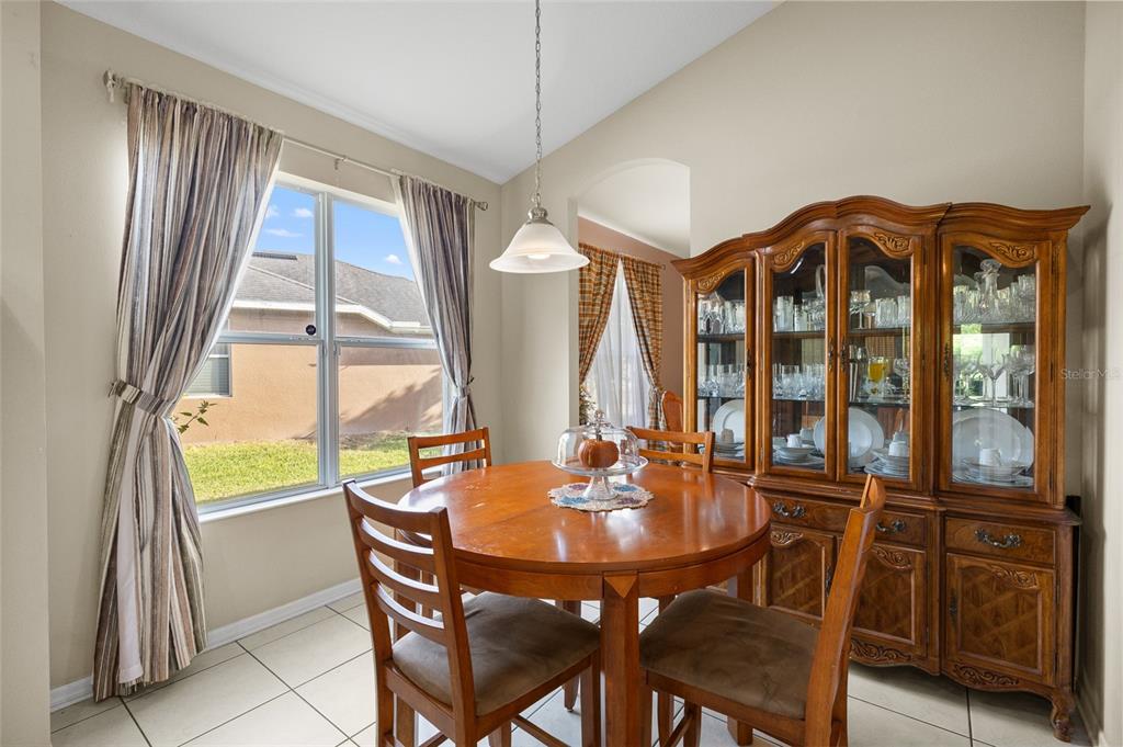 10925 Rockledge View Drive Riverview, FL 33579 - Photo 19 of 49 a dining room with wooden floor table and chairs