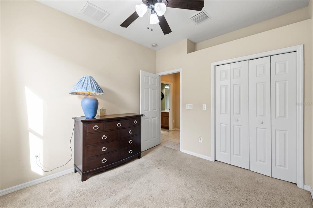 10925 Rockledge View Drive Riverview, FL 33579 - Photo 21 of 49 a room with a dresser and a chandelier