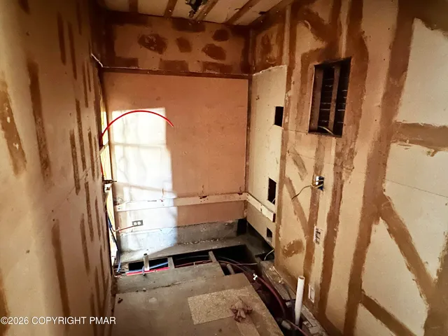 a bathroom with a toilet a sink and a mirror