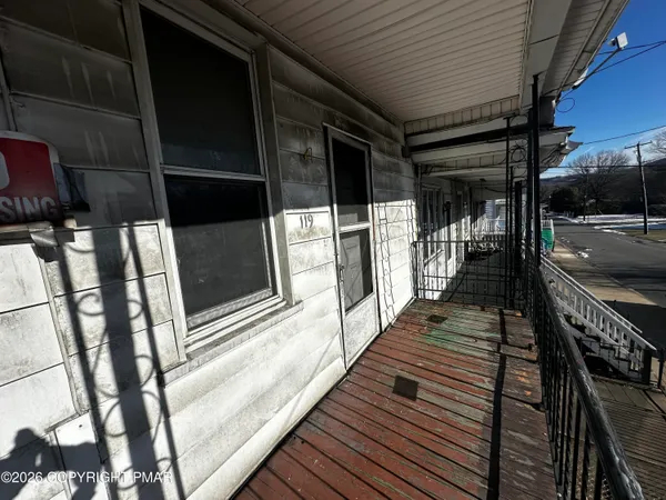 a view of entryway with a front door and wooden floor
