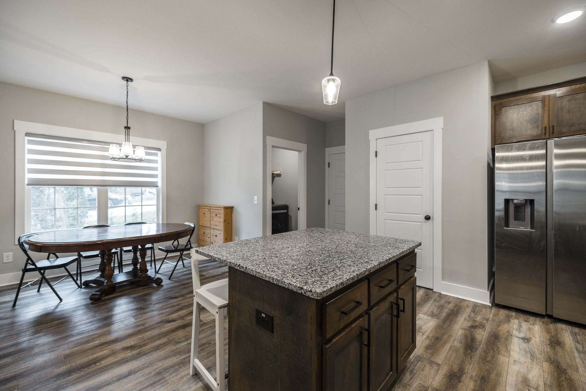 1845 Dinsmore Road Clarksville, TN 37040 - Photo 40 of 70 a kitchen with kitchen island a wooden floor and a refrigerator