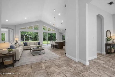 a lobby with furniture and floor to ceiling window