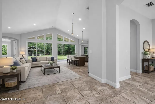 a lobby with furniture and floor to ceiling window