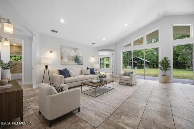a living room with furniture and large windows