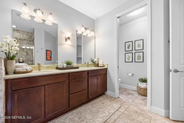a bathroom with a double vanity sink and a mirror