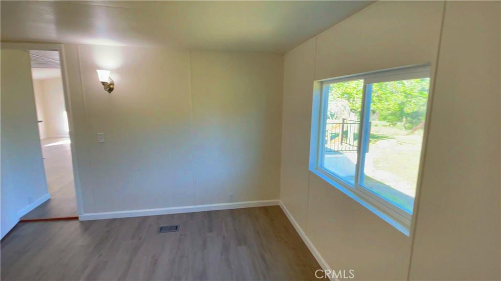 5440 Darrah Road Mariposa, CA 95338 - Photo 15 of 26 an empty room with wooden floor and windows