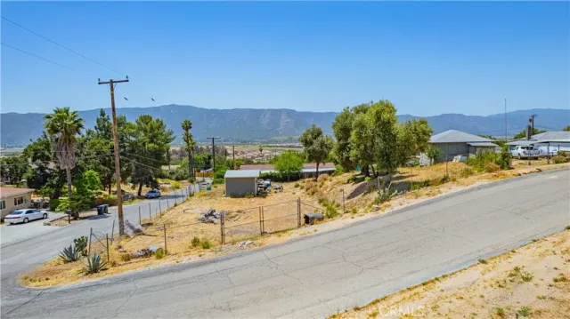 a view of a terrace with furniture and a garden
