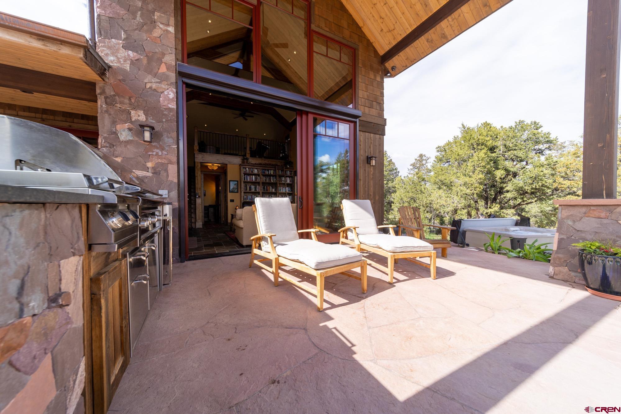 6534 Pleasant Point Drive Ridgway, CO 81432 - Photo 11 of 35 a view of a patio with a table and chairs and a barbeque