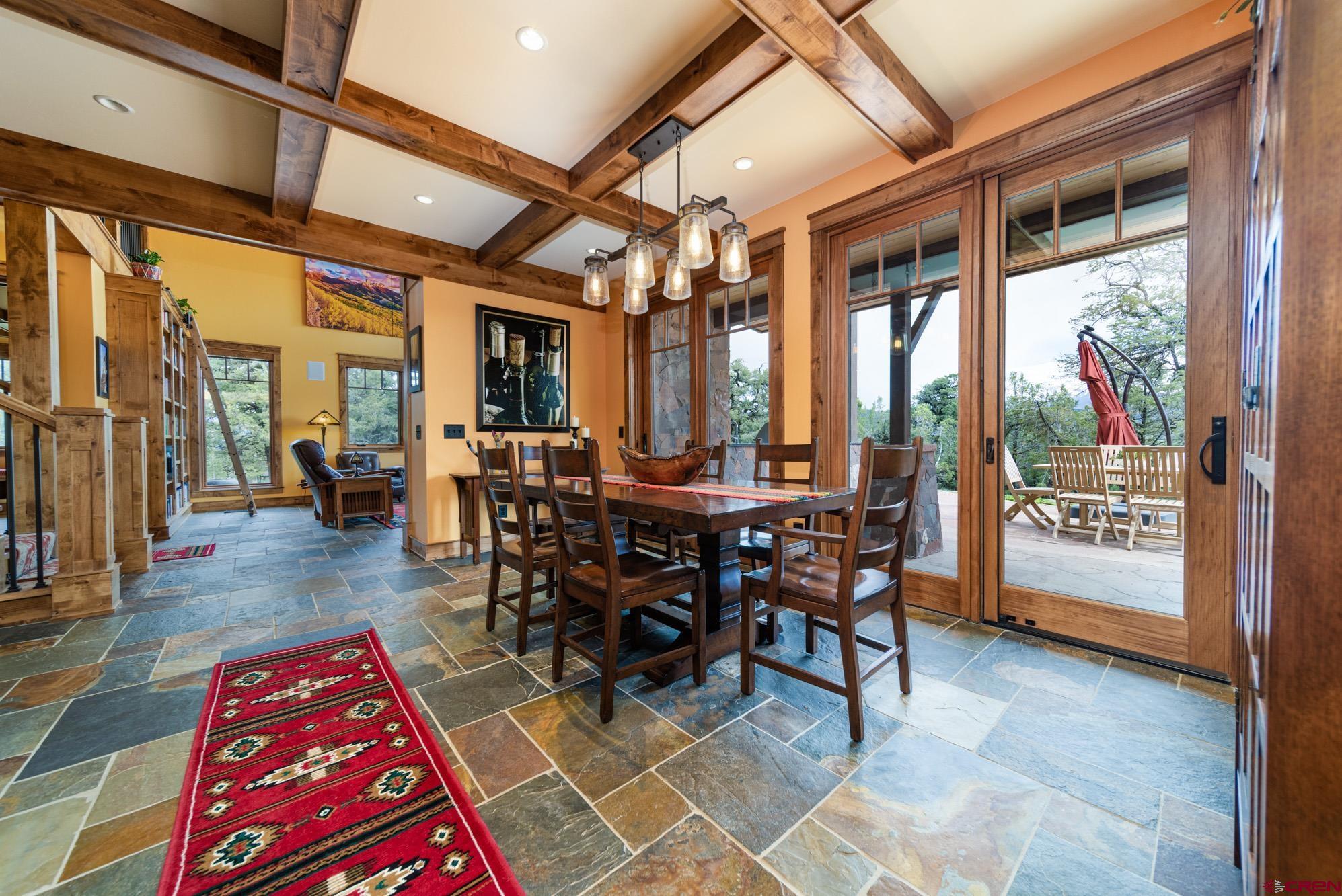6534 Pleasant Point Drive Ridgway, CO 81432 - Photo 14 of 35 a view of a dining room with furniture window and wooden floor