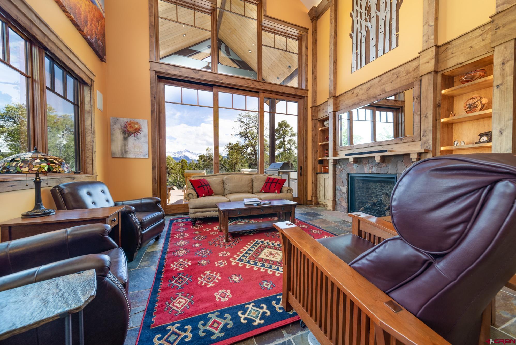 6534 Pleasant Point Drive Ridgway, CO 81432 - Photo 18 of 35 a living room with furniture a rug and a floor to ceiling window