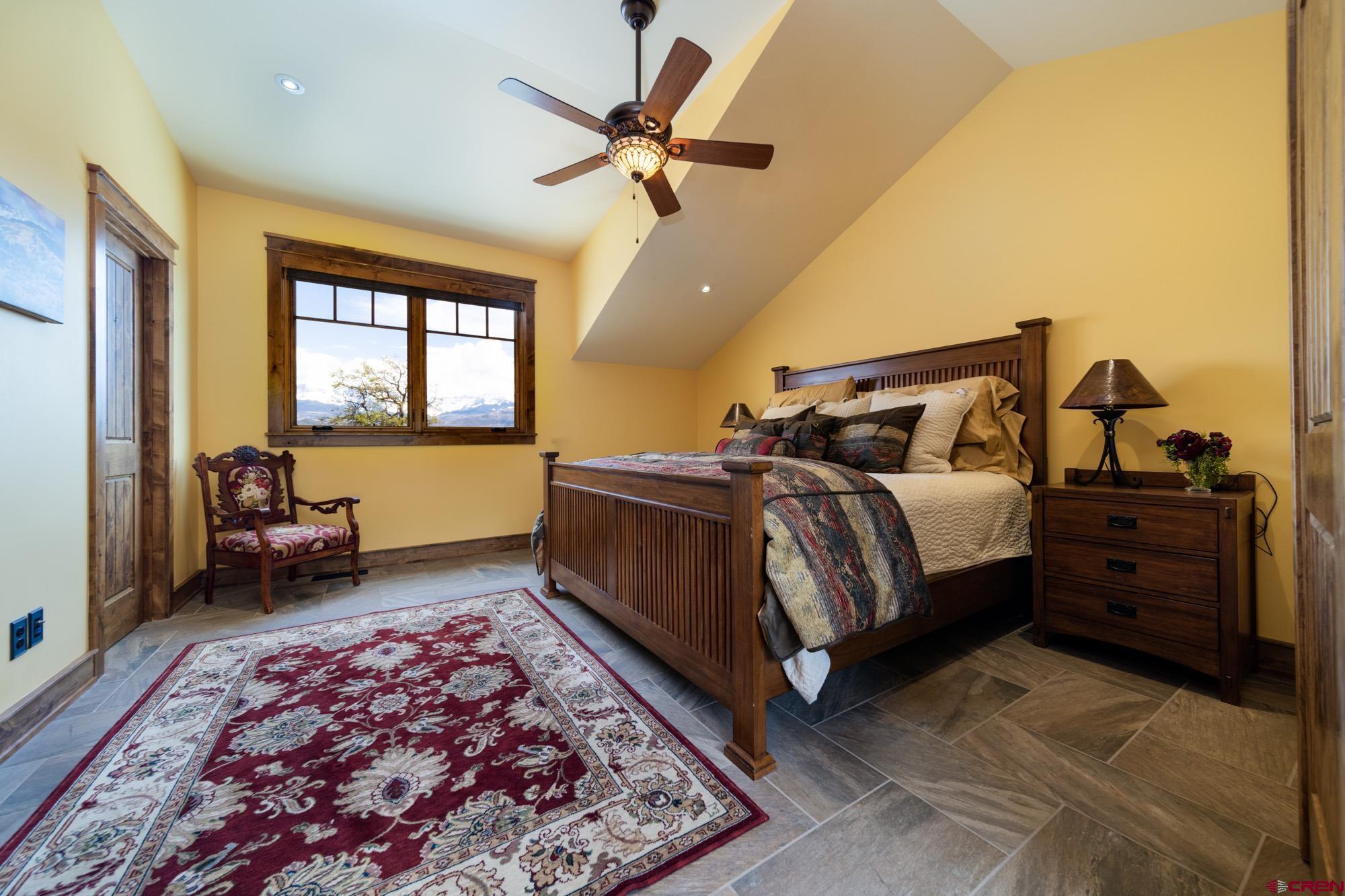 6534 Pleasant Point Drive Ridgway, CO 81432 - Photo 25 of 35 a bedroom with a bed and a couch