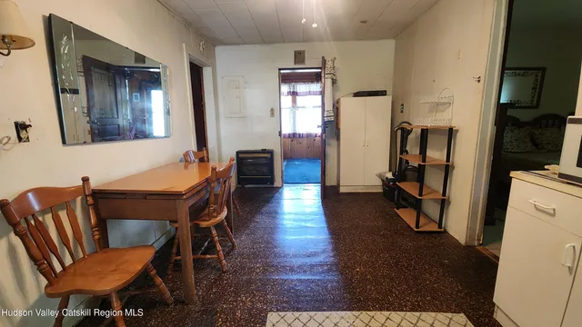 a living room with furniture a large window and red walls