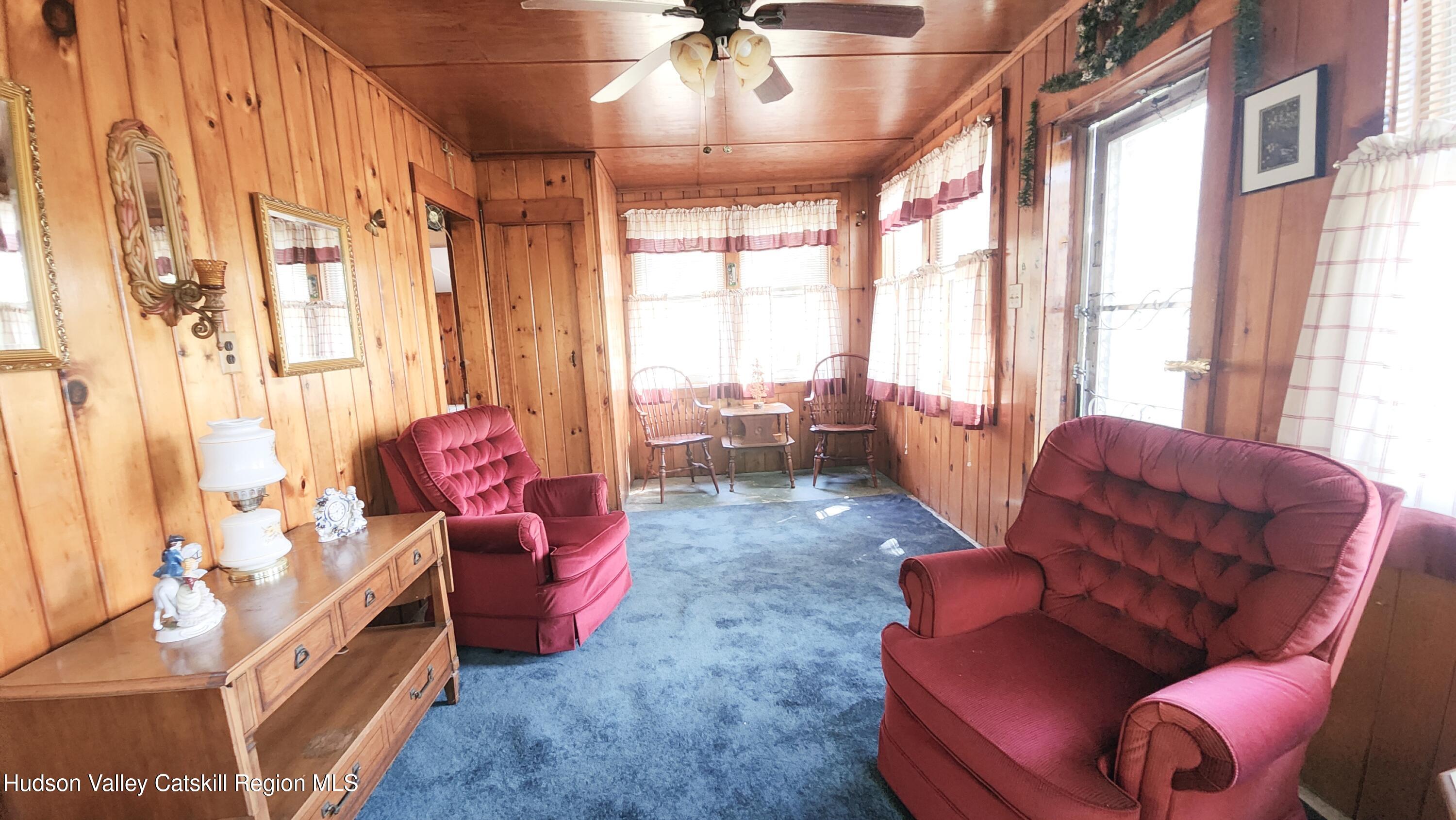 8702 Highway 32 Cairo, NY 12413 - Photo 6 of 14 a living room with furniture and a large window