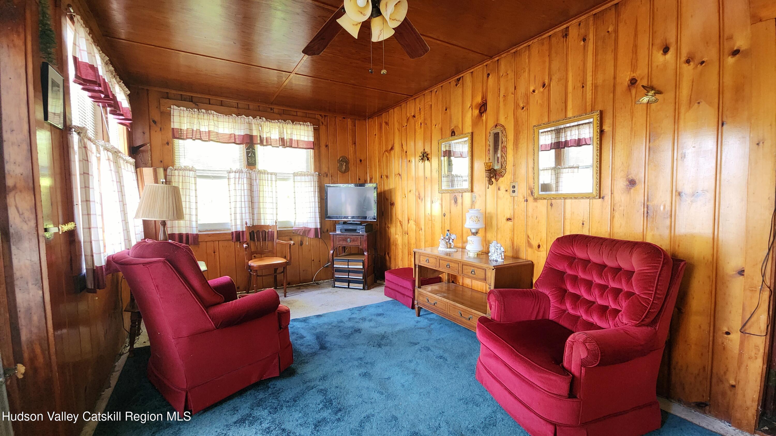 8702 Highway 32 Cairo, NY 12413 - Photo 7 of 14 a living room with furniture a large window and red walls