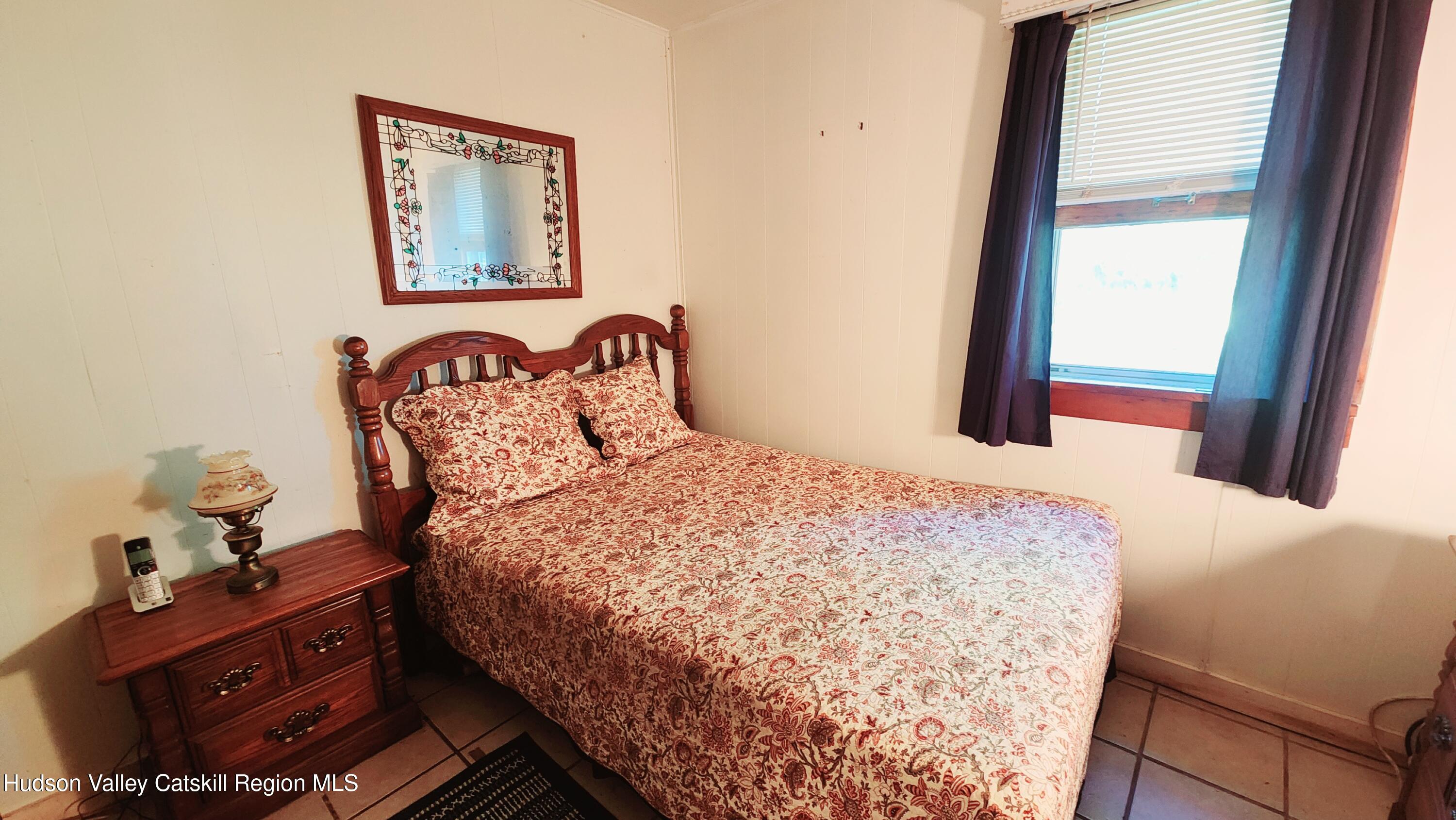 8702 Highway 32 Cairo, NY 12413 - Photo 8 of 14 a bedroom with a bed and a window