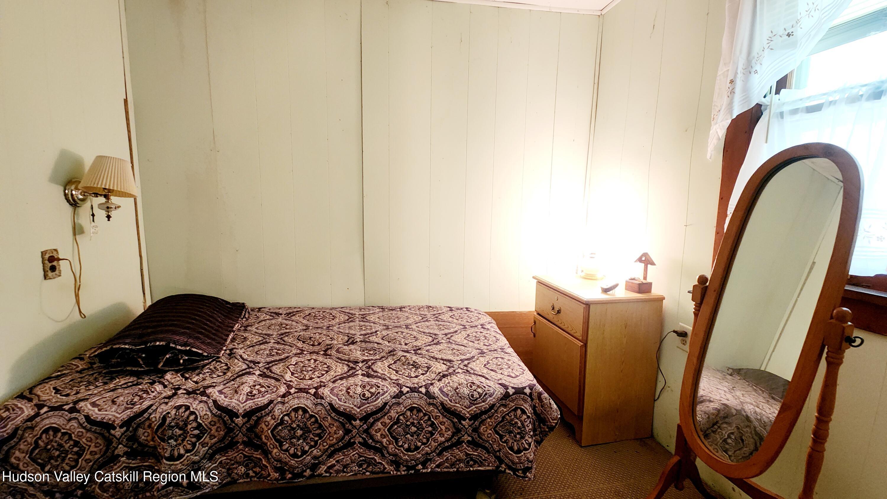 8702 Highway 32 Cairo, NY 12413 - Photo 10 of 14 a bedroom with a bed and a dresser