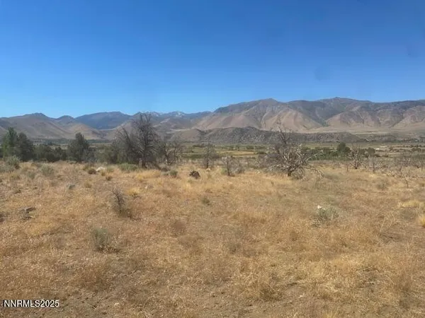 a view of a large mountain with a mountain in the background