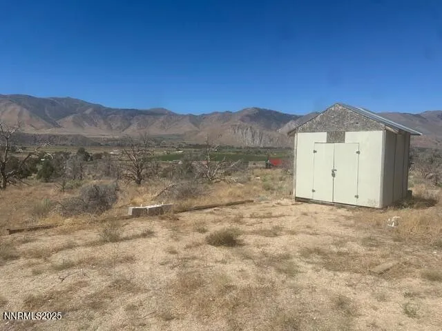 a view of a dry yard with mountain